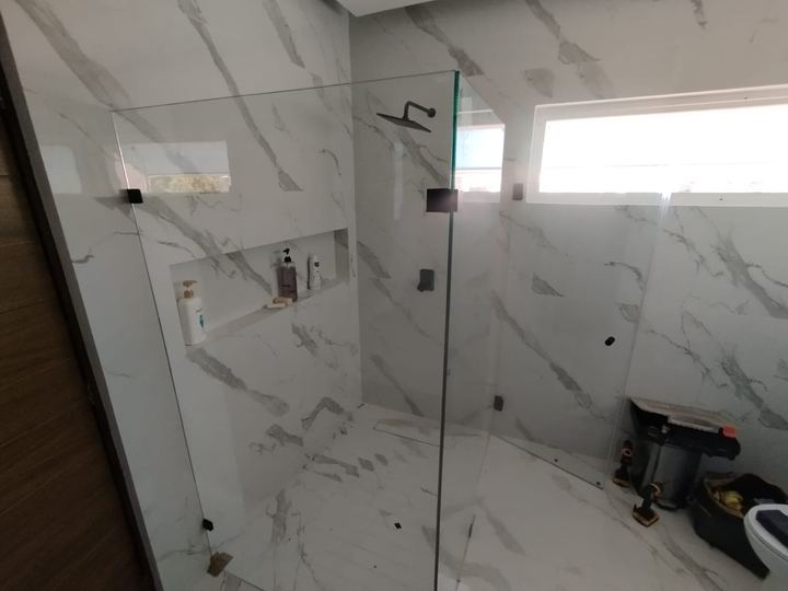 Cancel de baño en vidrio templado sobre acabado de mármol